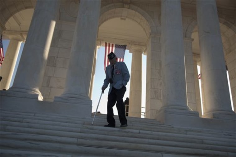People arrive at the Amphitheater at Arlington National Cemetery in Arlington, V., Friday, Nov. 11, 2011, for a Veterans Day ceremony where President Barack Obama will speak.  (AP Photo/Evan Vucci)